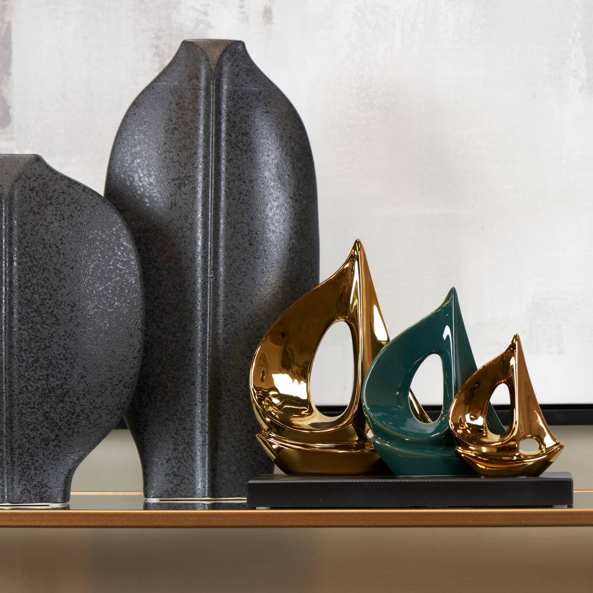 CosmoLiving by Cosmopolitan 12" Gold Porcelain Sail Boat Sculpture with Black Base